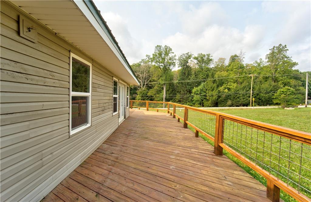 1276 Glades Pike Somerset, PA 15501 - Photo 8 of 32 a view of a balcony with wooden floor and fence and trees