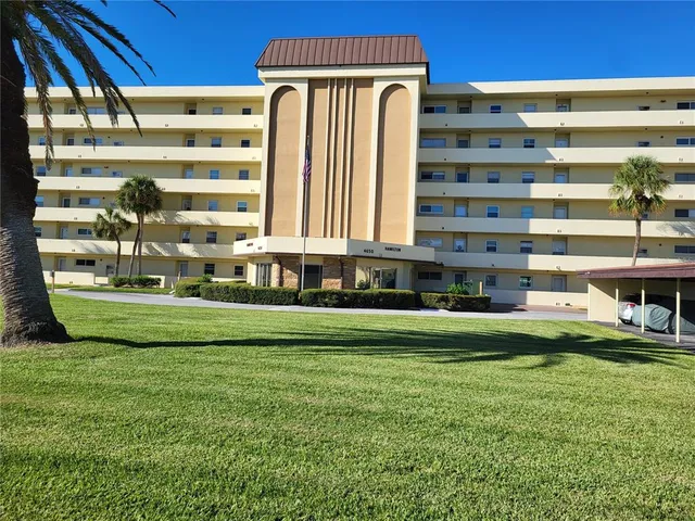a front view of a building with a yard