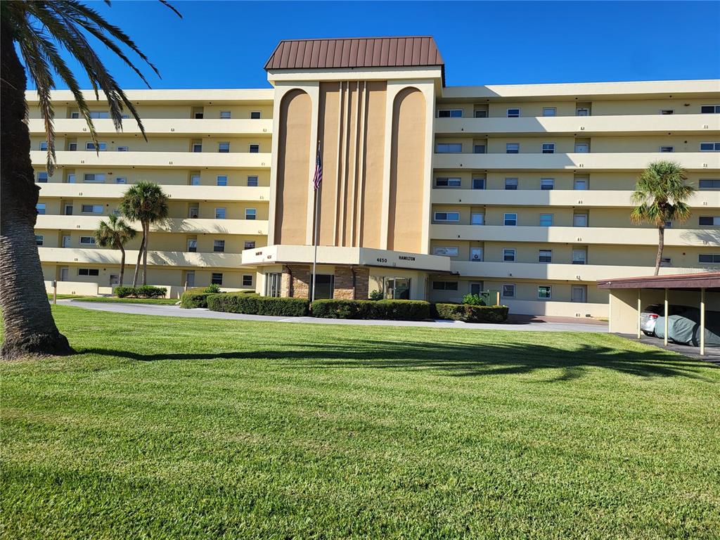 a front view of a building with a yard