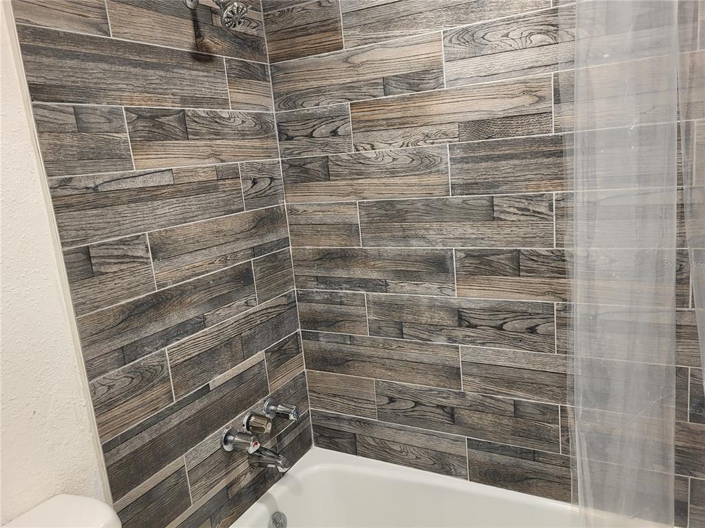 4650 Cove Circle, Unit 611 St. Petersburg, FL 33708 - Photo 11 of 25 a bathroom with a shower