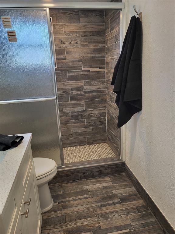 4650 Cove Circle, Unit 611 St. Petersburg, FL 33708 - Photo 13 of 25 a bathroom with a toilet and a shower