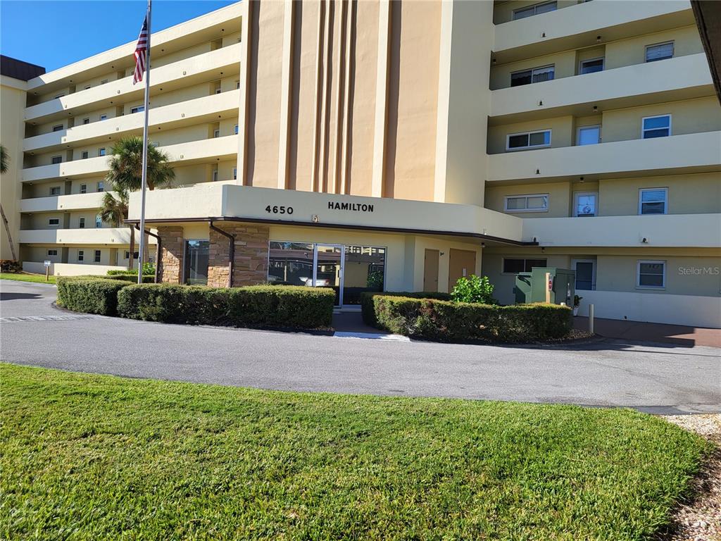 4650 Cove Circle, Unit 611 St. Petersburg, FL 33708 - Photo 15 of 25 a front view of a building with a garden