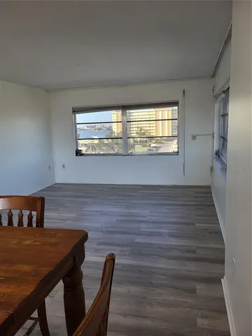 a view of a dining room with furniture and window