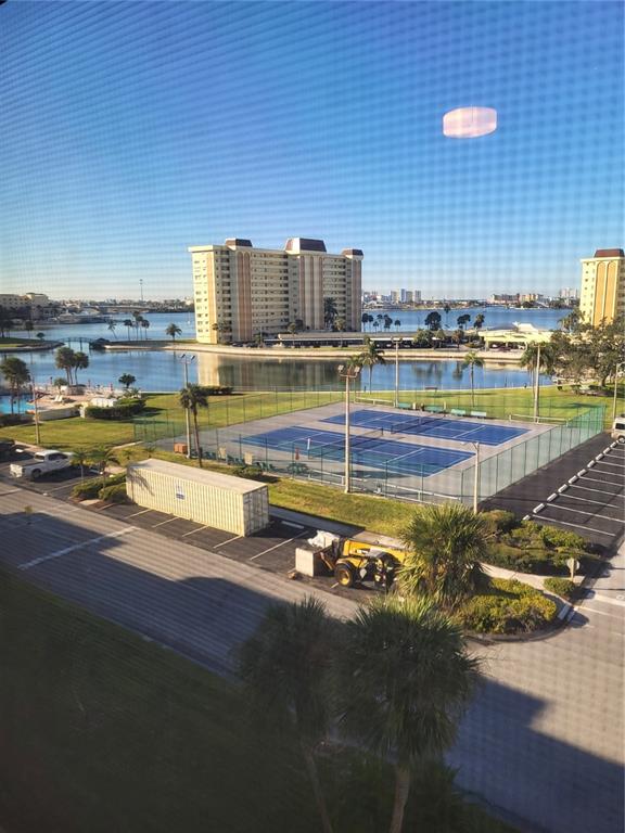 4650 Cove Circle, Unit 611 St. Petersburg, FL 33708 - Photo 6 of 25 a view of a swimming pool with outdoor seating and yard