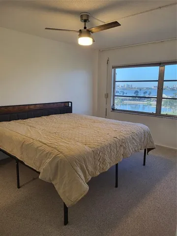 a bed sitting in a bedroom next to a window