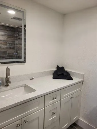 a sink with white cabinets