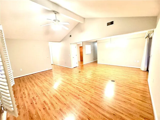 a view of a room with wooden floor
