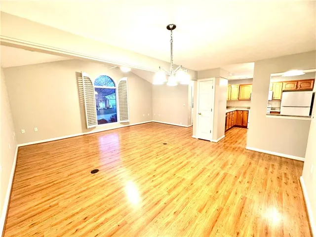 a view of a room with wooden floor