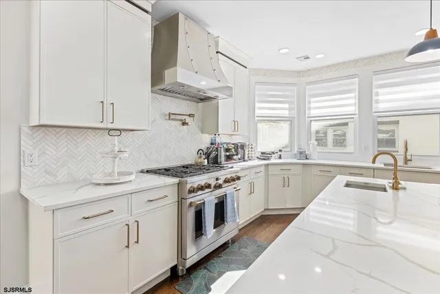 a kitchen with stainless steel appliances granite countertop a sink stove and cabinets