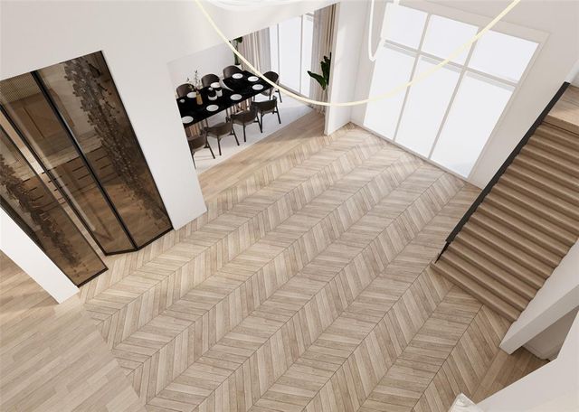 a view of a bedroom with wooden floor and stairs