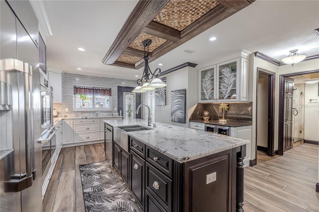 345 Boca Ciega Point Boulevard St. Petersburg, FL 33708 - Photo 11 of 64 a kitchen with granite countertop a stove oven and a refrigerator