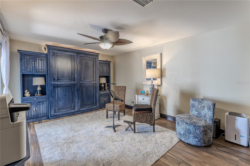 345 Boca Ciega Point Boulevard St. Petersburg, FL 33708 - Photo 12 of 64 a workspace room with furniture and wooden floor