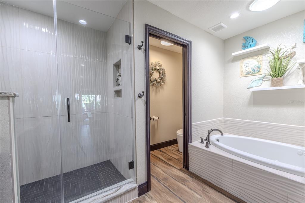 345 Boca Ciega Point Boulevard St. Petersburg, FL 33708 - Photo 26 of 64 a bathroom with a bathtub and a shower
