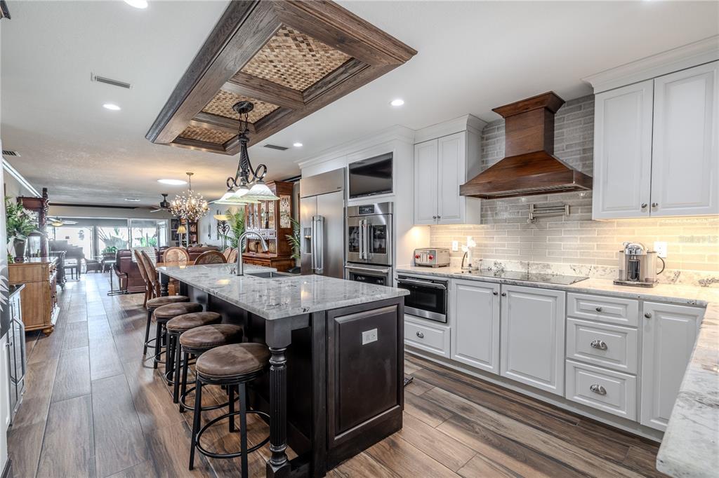 345 Boca Ciega Point Boulevard St. Petersburg, FL 33708 - Photo 5 of 64 a kitchen with stainless steel appliances granite countertop a stove a refrigerator and a wooden floors
