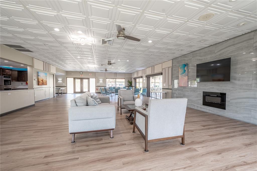 345 Boca Ciega Point Boulevard St. Petersburg, FL 33708 - Photo 57 of 64 a living room with fireplace furniture and a flat screen tv