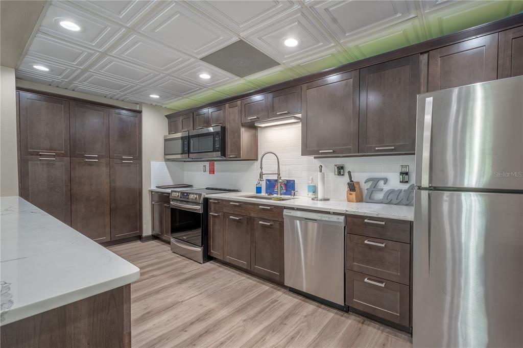 345 Boca Ciega Point Boulevard St. Petersburg, FL 33708 - Photo 59 of 64 a kitchen with a refrigerator sink and cabinets