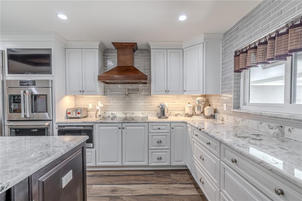 345 Boca Ciega Point Boulevard St. Petersburg, FL 33708 - Photo 8 of 64 a kitchen with stainless steel appliances granite countertop a sink stove and cabinets