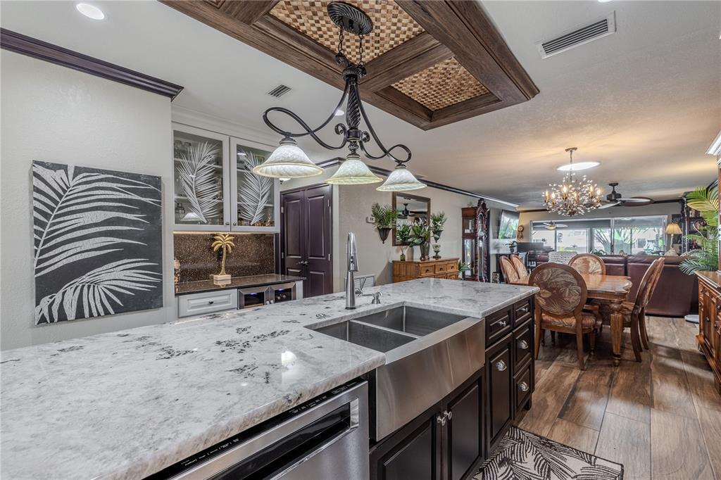 345 Boca Ciega Point Boulevard St. Petersburg, FL 33708 - Photo 10 of 64 a kitchen with stainless steel appliances granite countertop a sink a stove and a table
