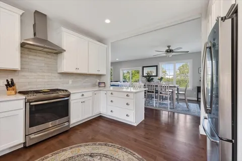 a kitchen with white cabinets and stainless steel appliances
