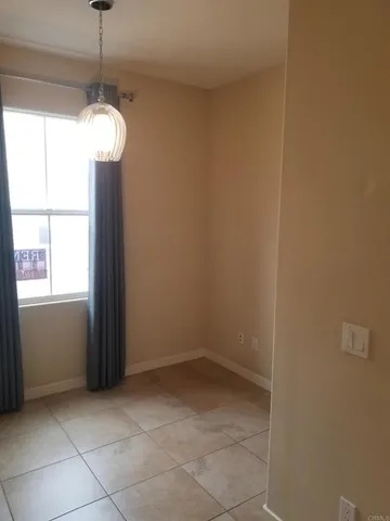 a view of a room with a windows and ceiling fan