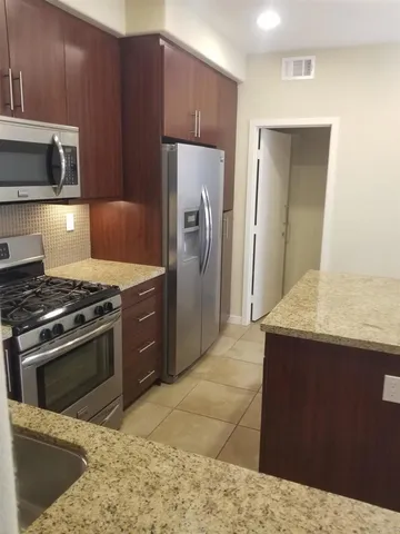 a kitchen with a stove and a refrigerator