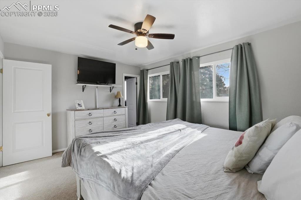 2918 Flintridge Square Colorado Springs, CO 80918 - Photo 19 of 49 a bedroom with a large bed and a flat screen tv