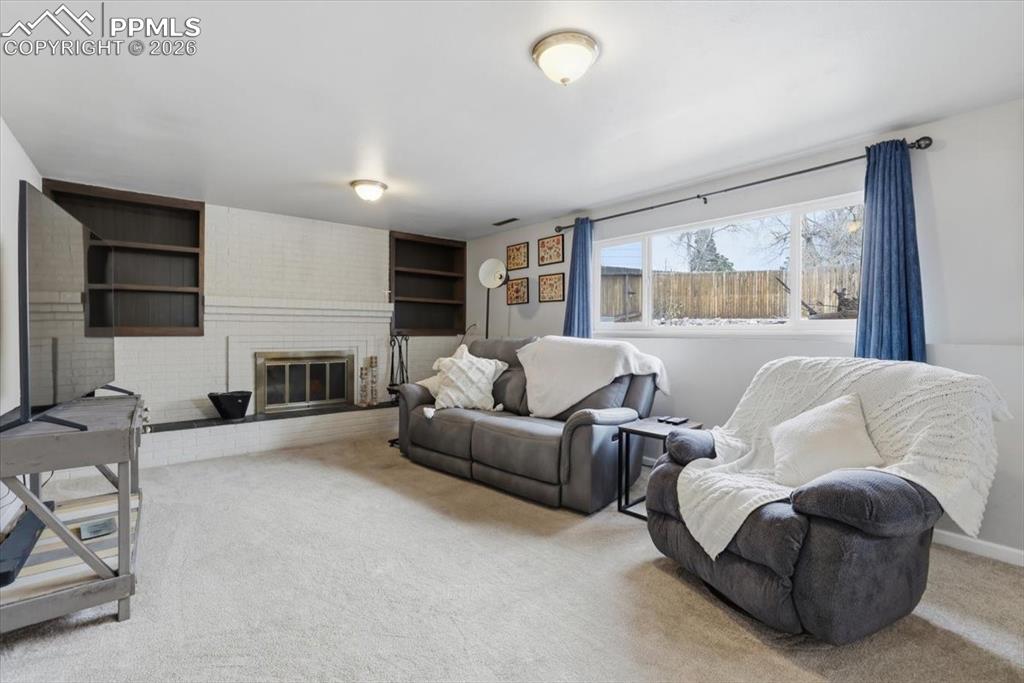 2918 Flintridge Square Colorado Springs, CO 80918 - Photo 32 of 49 a living room with furniture and a fireplace