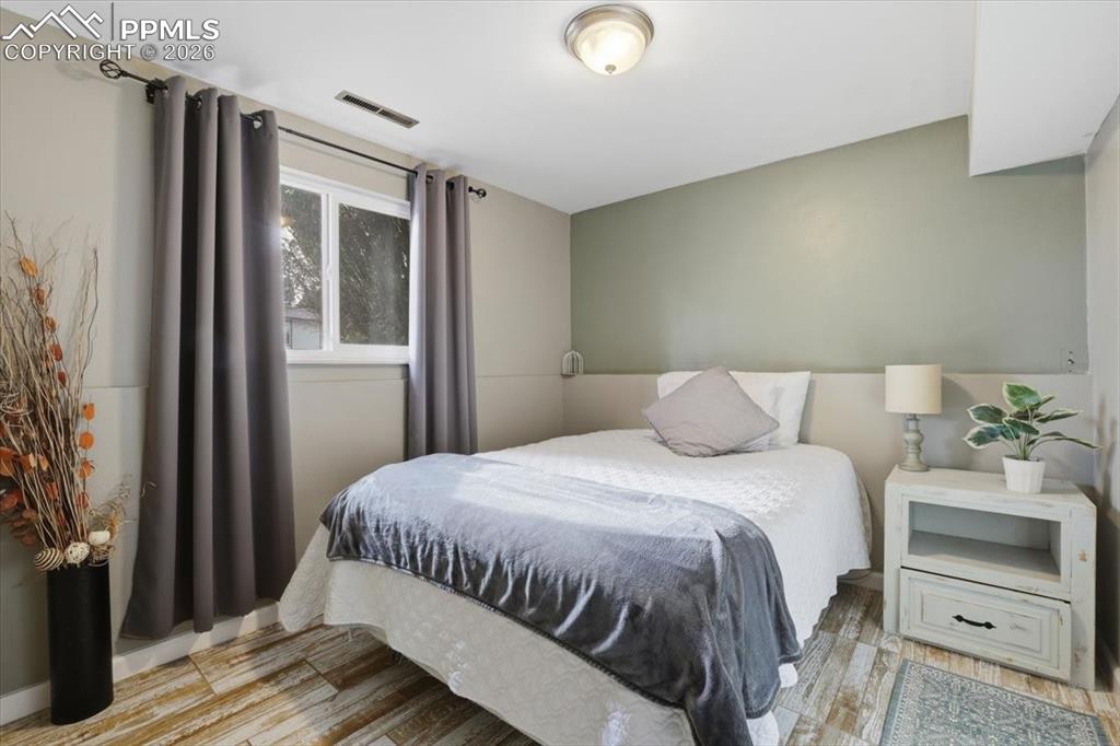 2918 Flintridge Square Colorado Springs, CO 80918 - Photo 35 of 49 a bedroom with a bed and a mirror