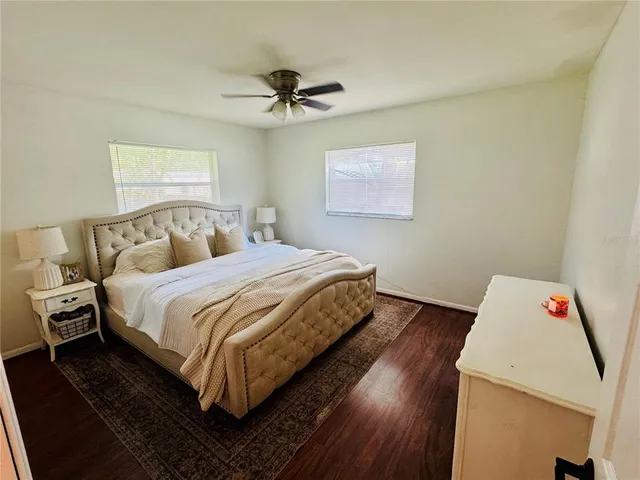 a bedroom with a bed and wooden floor