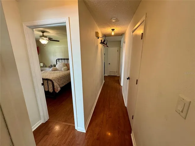 a bedroom with a bed window and a flat screen tv