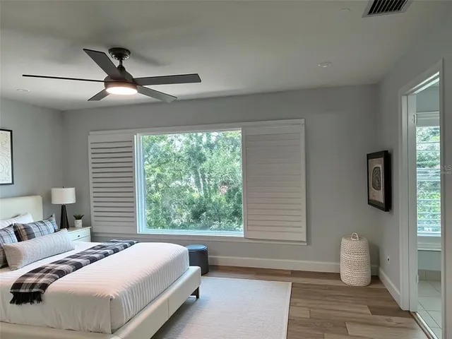 a bedroom with a large bed and a window