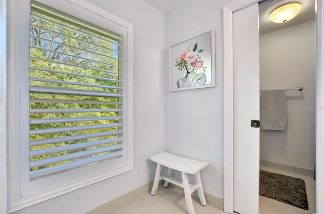 a view of a bedroom with a bed and a window