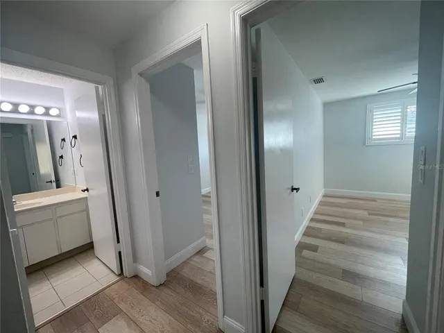 a view of a hallway with entryway and stairs