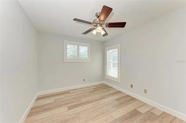 a view of a livingroom with a window and a ceiling fan