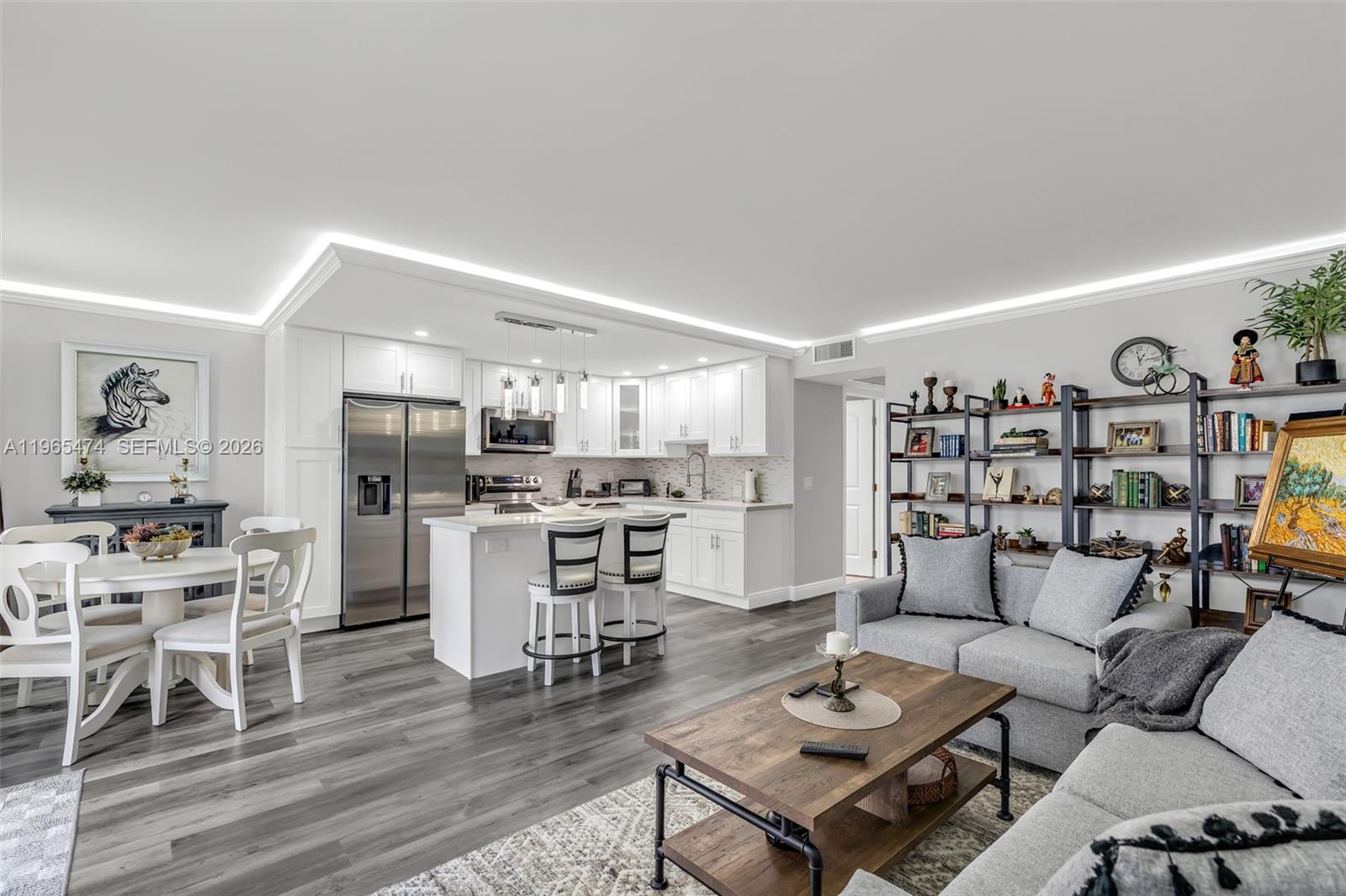 a living room with furniture and kitchen view