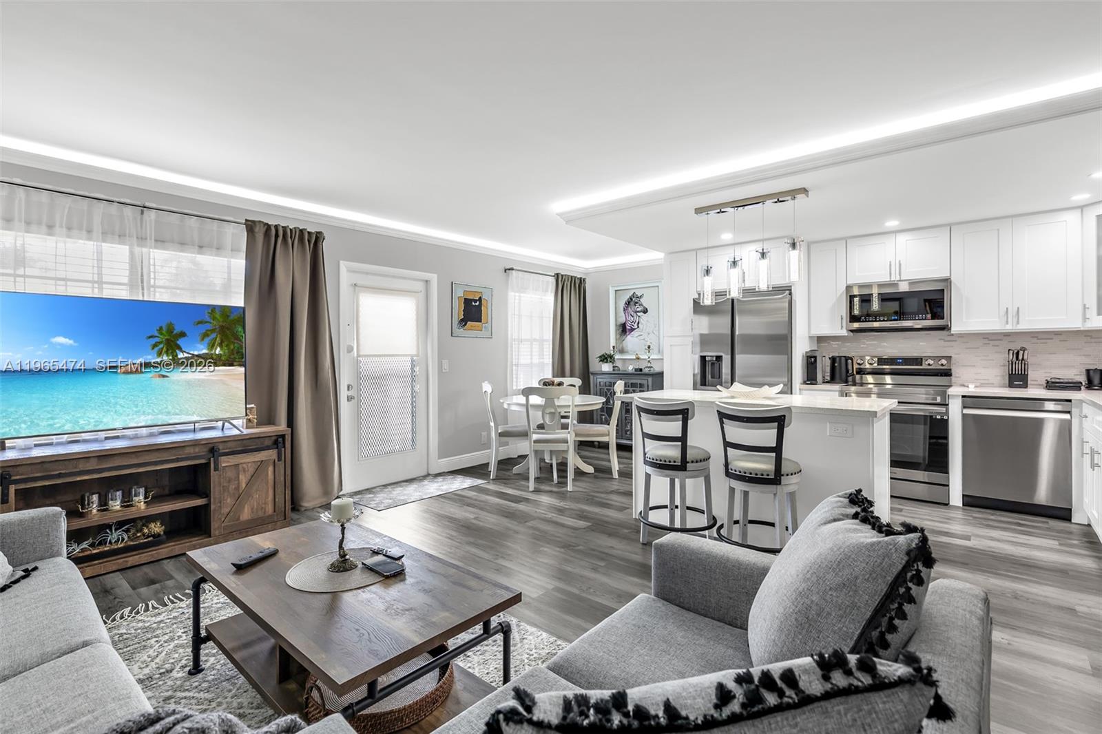 152 Dorset D, Unit 152 Boca Raton, FL 33434 - Photo 12 of 31 a living room with lots of furniture and kitchen view