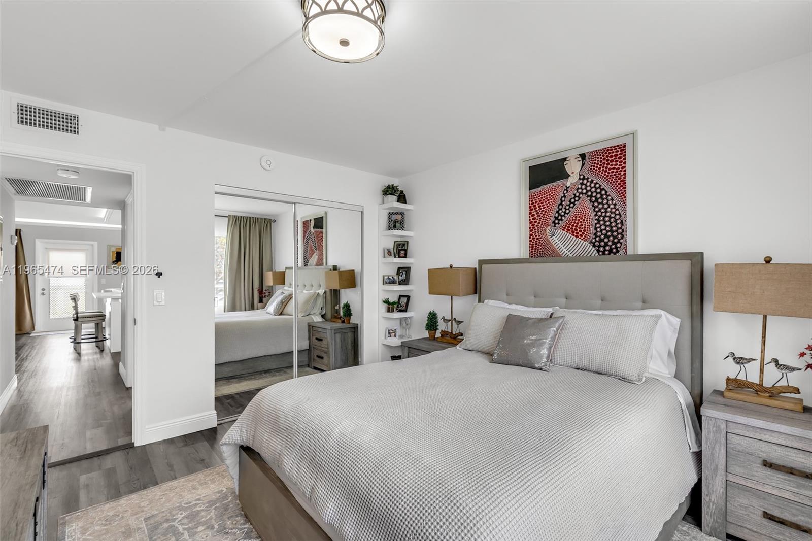 152 Dorset D, Unit 152 Boca Raton, FL 33434 - Photo 15 of 31 a bedroom with bed and wooden floor