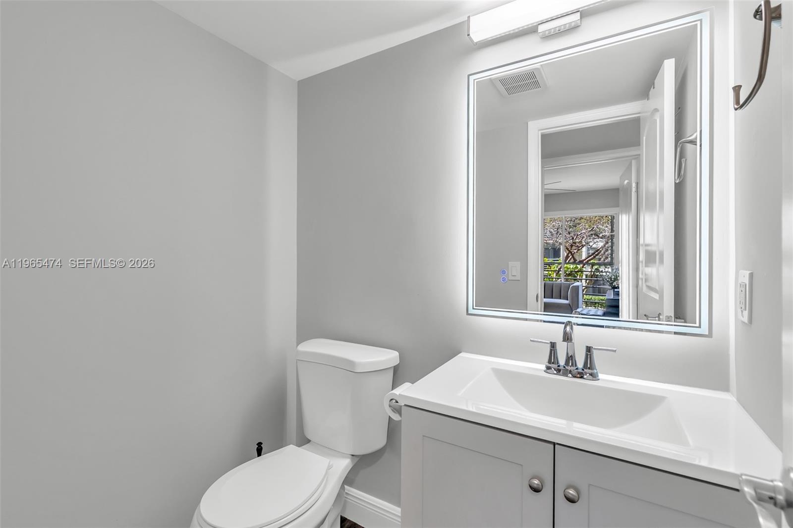 152 Dorset D, Unit 152 Boca Raton, FL 33434 - Photo 16 of 31 a bathroom with a toilet sink and mirror