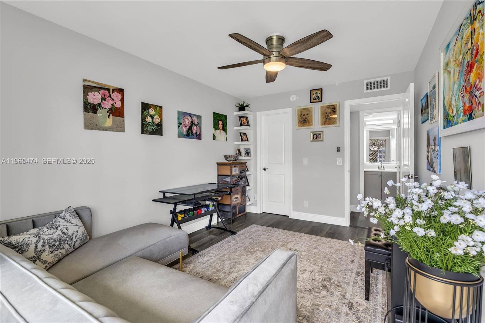152 Dorset D, Unit 152 Boca Raton, FL 33434 - Photo 18 of 31 a living room with furniture and flowers