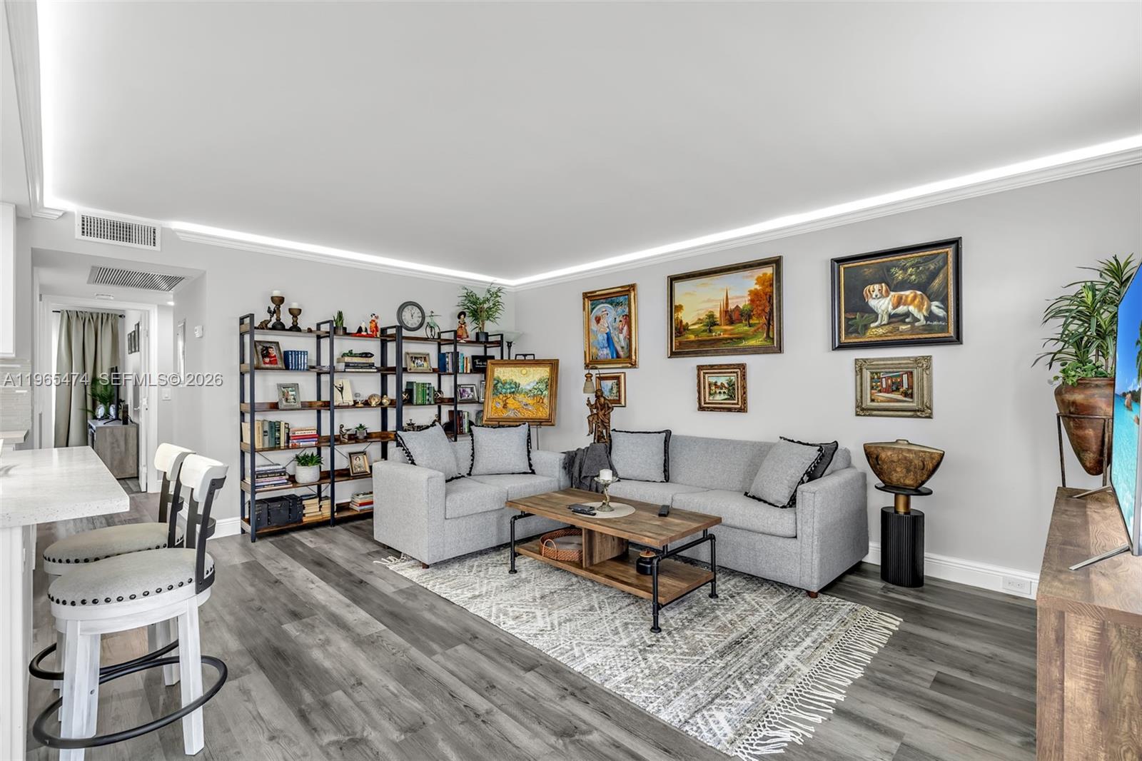 152 Dorset D, Unit 152 Boca Raton, FL 33434 - Photo 10 of 31 a living room with furniture and wooden floor