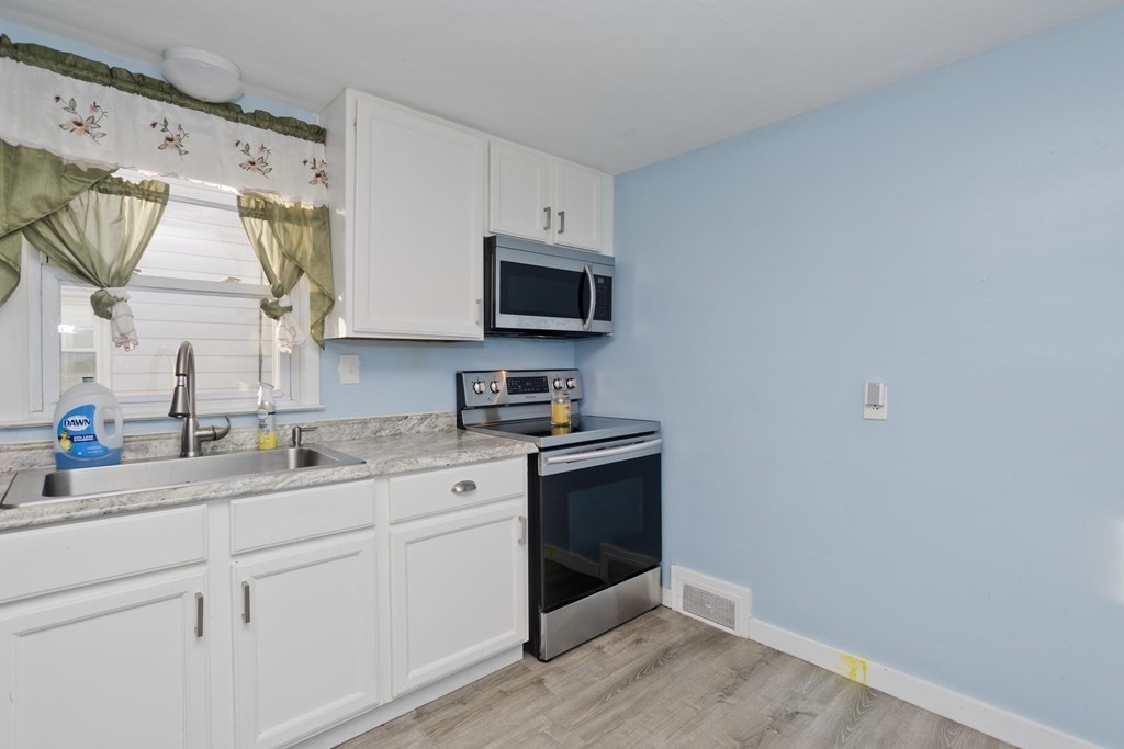 33 Campechi Street Springfield, MA 01104 - Photo 11 of 37 a kitchen with stainless steel appliances granite countertop a sink and a microwave
