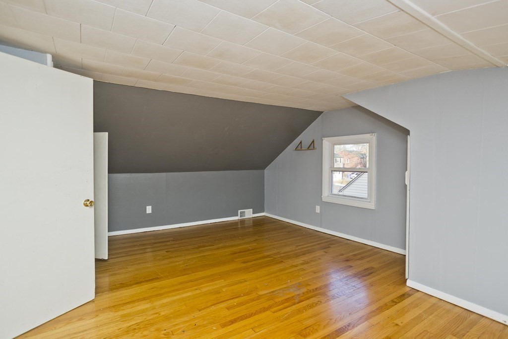 33 Campechi Street Springfield, MA 01104 - Photo 23 of 37 a view of an empty room with wooden floor and a window
