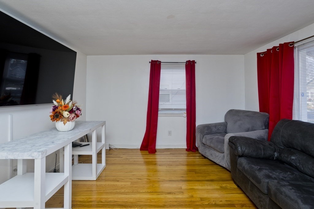 33 Campechi Street Springfield, MA 01104 - Photo 5 of 37 a living room with furniture and a wooden floor