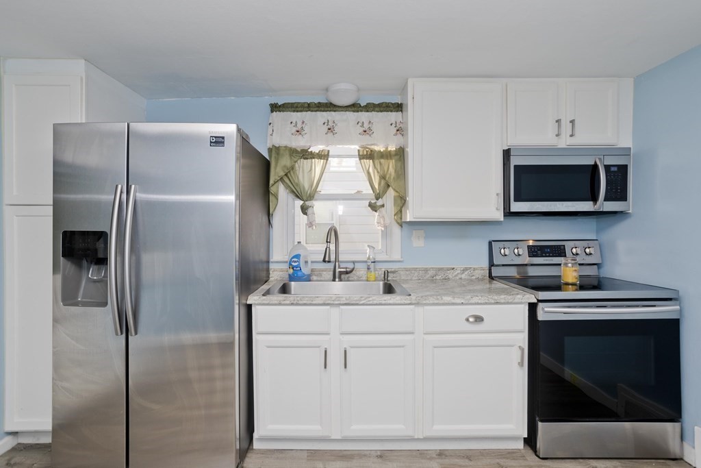 33 Campechi Street Springfield, MA 01104 - Photo 8 of 37 a kitchen with a refrigerator sink and microwave
