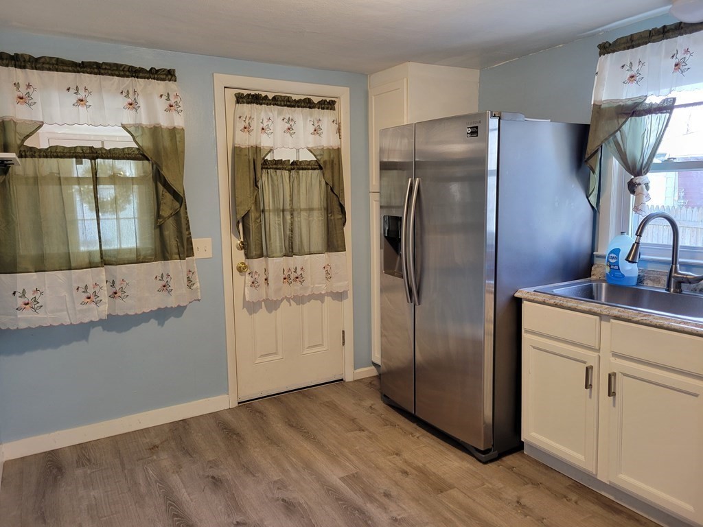 33 Campechi Street Springfield, MA 01104 - Photo 9 of 37 a kitchen with stainless steel appliances a refrigerator and a stove