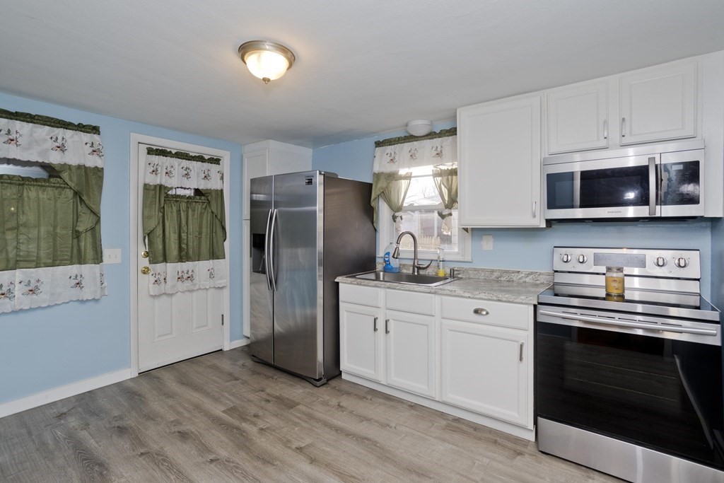 33 Campechi Street Springfield, MA 01104 - Photo 10 of 37 a kitchen with stainless steel appliances a stove microwave and refrigerator