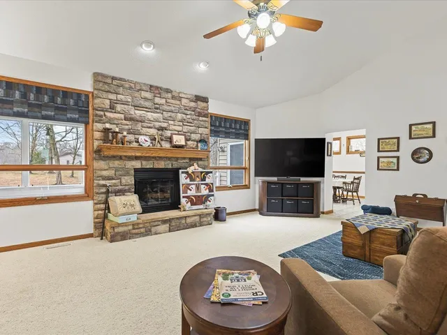a living room with furniture a flat screen tv and a fireplace