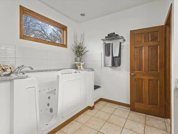 a view of a room with wooden floor and fence