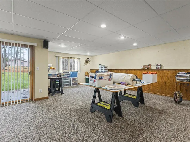 a living room with furniture a flat screen tv and a table