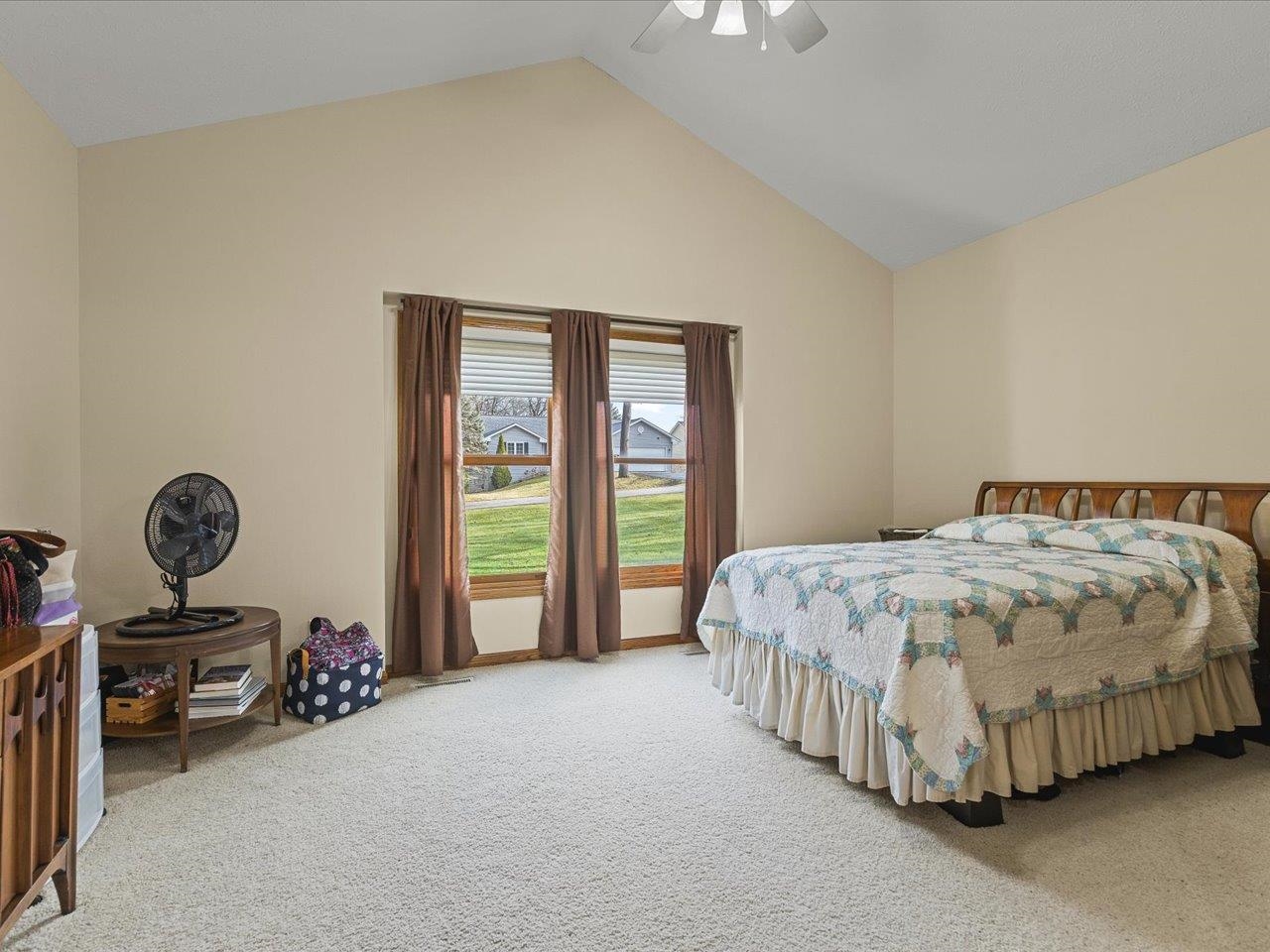 625 Lake Summerset Road Lake Summerset, IL 61019 - Photo 31 of 51 a spacious bedroom with a bed and a chandelier